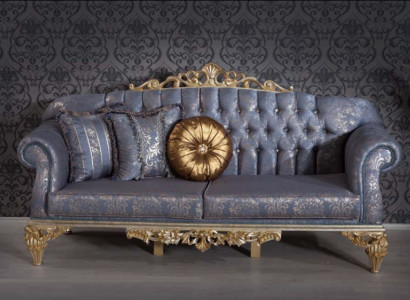 Sophisticated Classic sofa in Chesterfield design for the living room with golden cushions